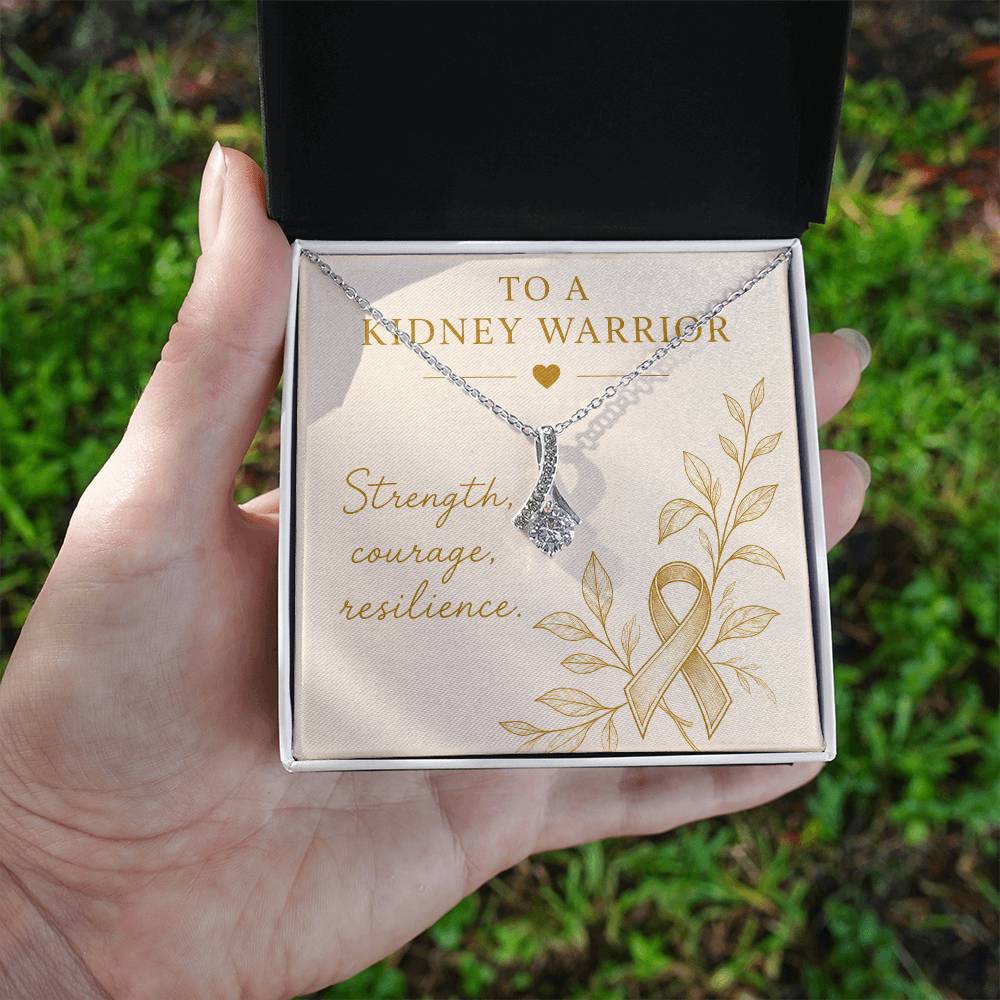 Kidney Warrior necklace held in sunlight